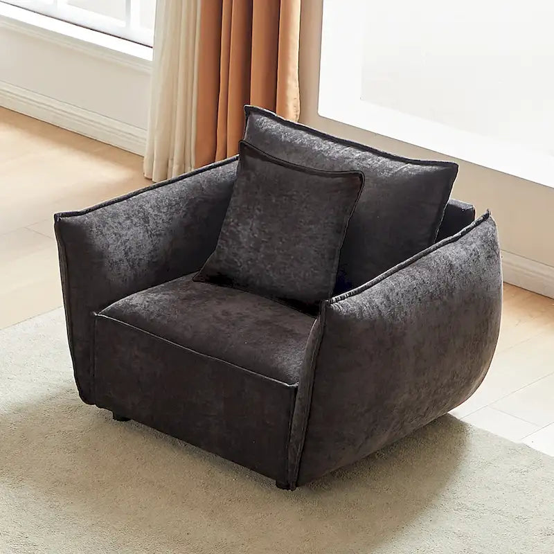 Black Upholstered Arm Chair with Pillows and Wide Cushion